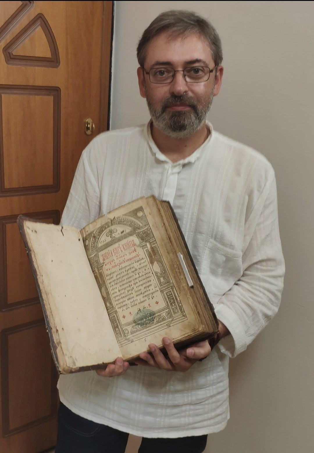 Dr. Serhii Shumylo holding one of the Ostrog Bible copies